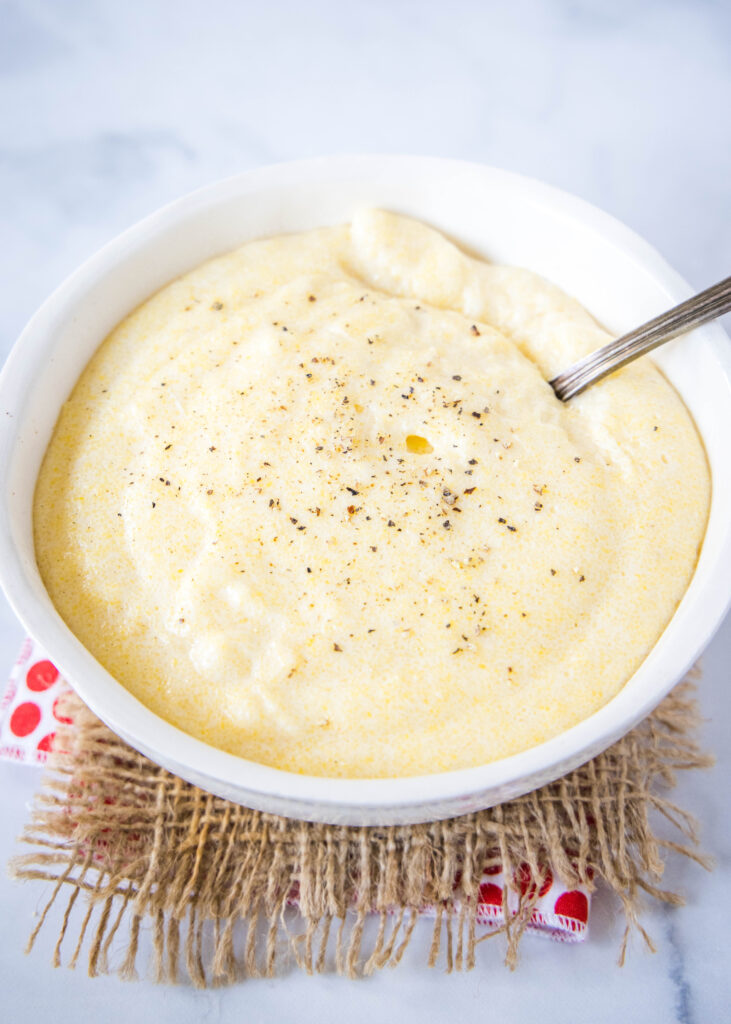 creamy polenta in a bowl with a spoon in it