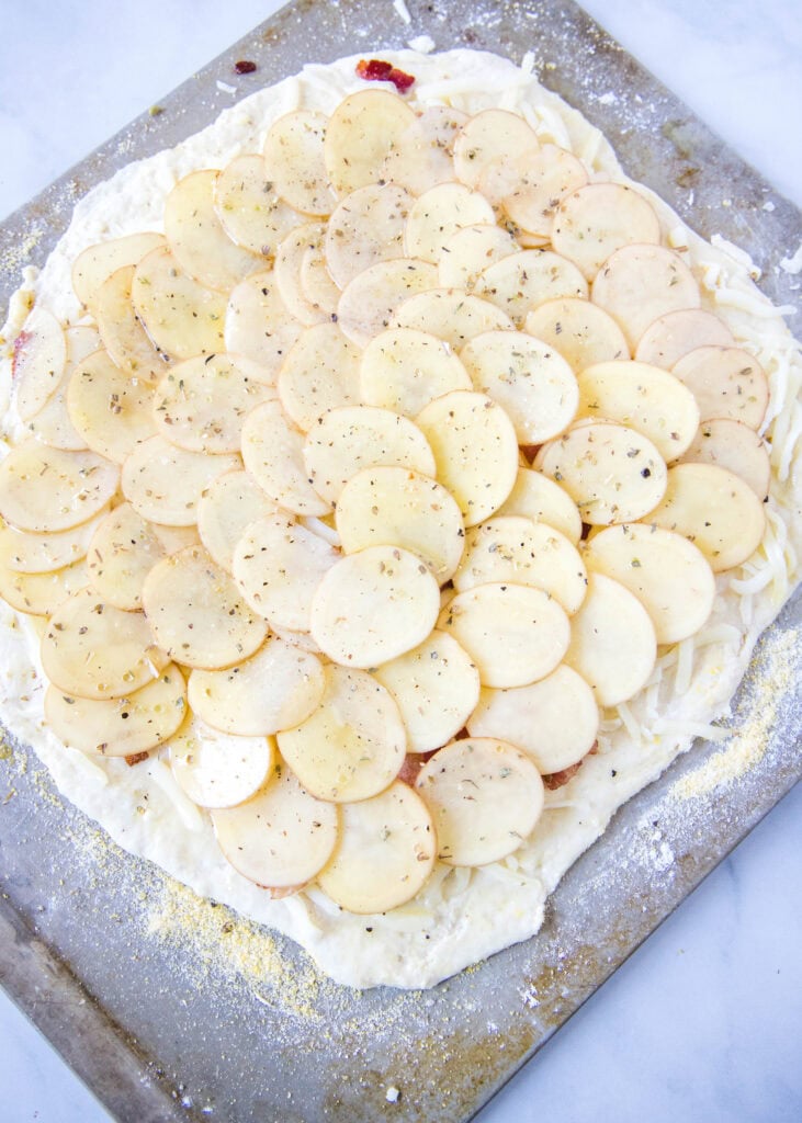 pizza with potatoes ready for the oven