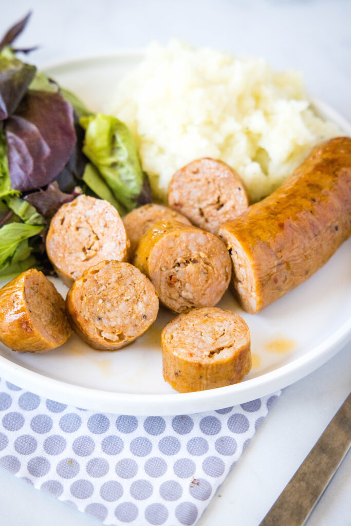 sliced sausage on a plate with potatoes