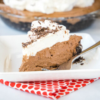 cropped square image of chocolate cream pie on white plate