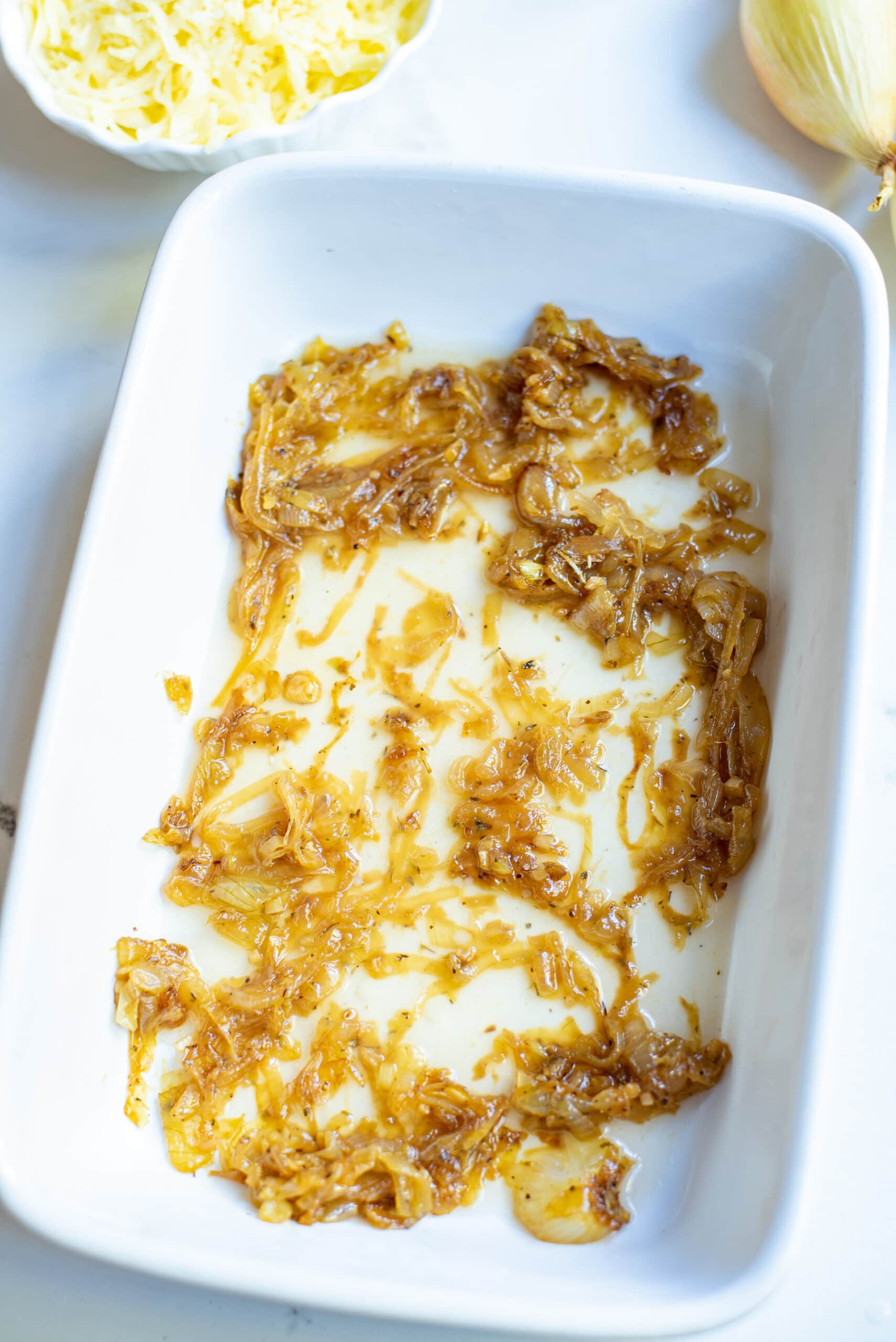 baking dish with caramelized onions and chicken broth