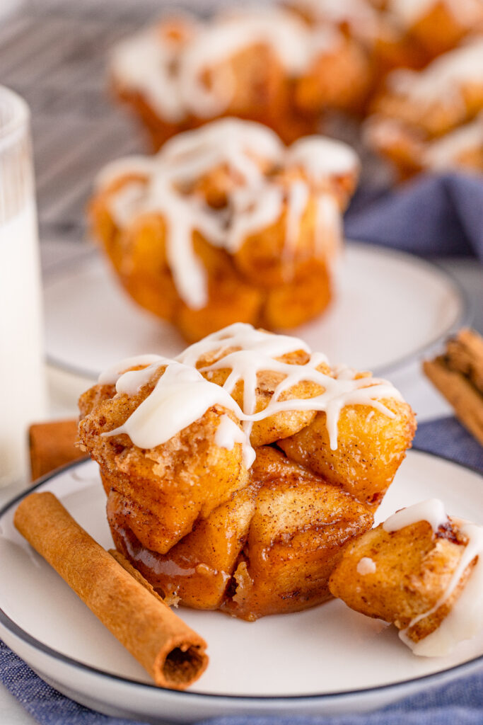 monkey bread muffins with glaze on white plate