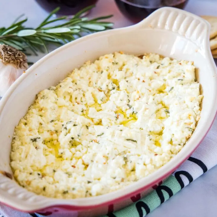 cropped in close up of baked goat cheese dip