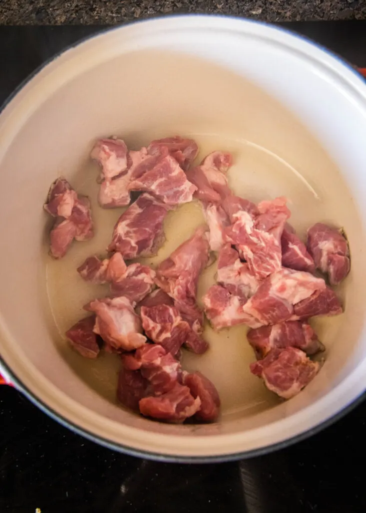 browning pork shoulder in a pot
