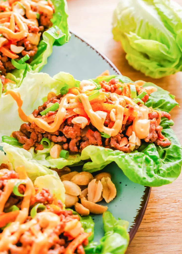 blue plate with lettuce wraps filled with ground beef
