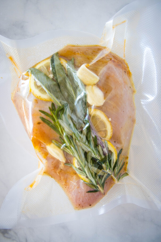 turkey in vaccum sealed bag with herbs, lemon slices and garlic