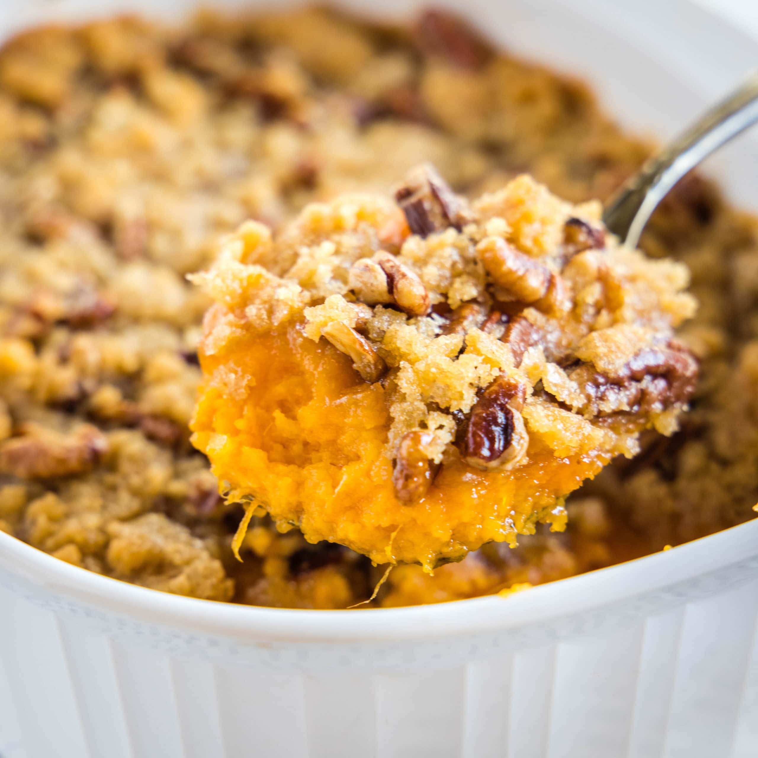 close up of ruth chris sweet potato casserole on a serving spoon