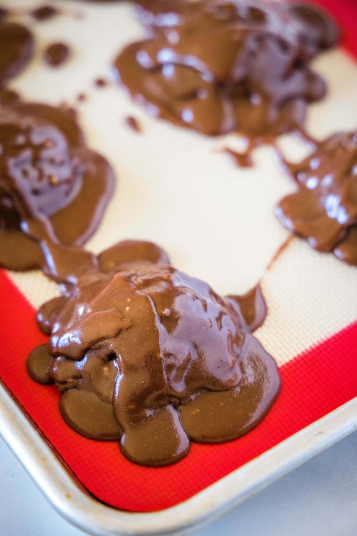 frosting poured over cookies on baking tray