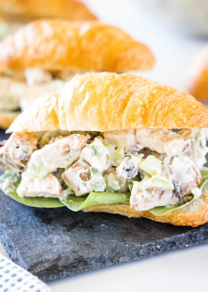 croissant with turkey salad on a tray