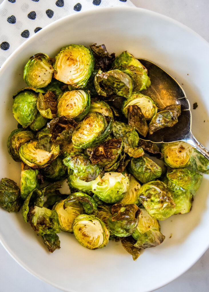 looking down at air fryer brussel sprouts in a white bowl