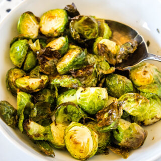 cropped in close of up brussel sprouts in a white bowl