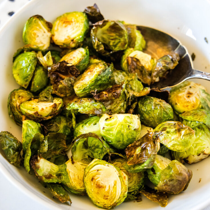 cropped in close of up brussel sprouts in a white bowl