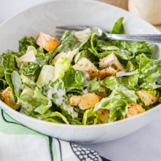 cropped in close up of chicken caesar salad in a bowl