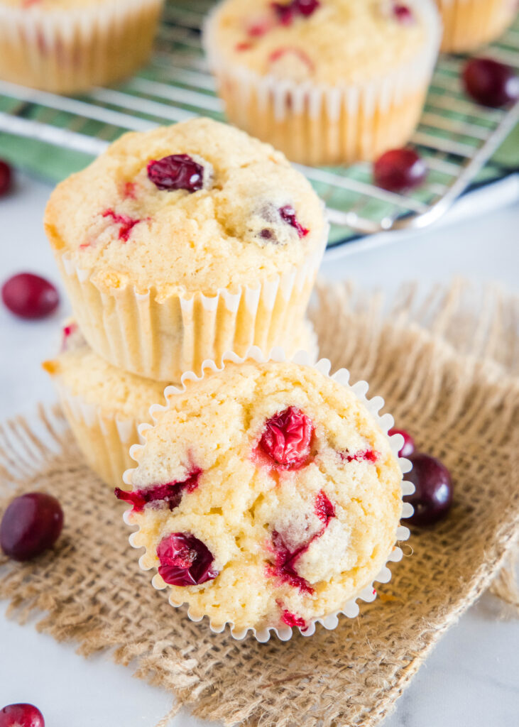 cranberry orange muffins stacked on a table