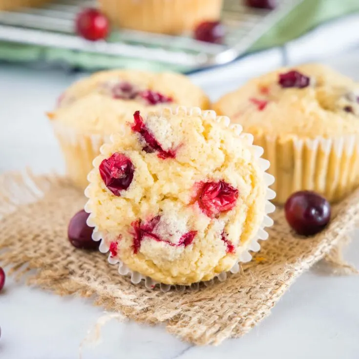cropped in close up of cranberry orange muffins on a table