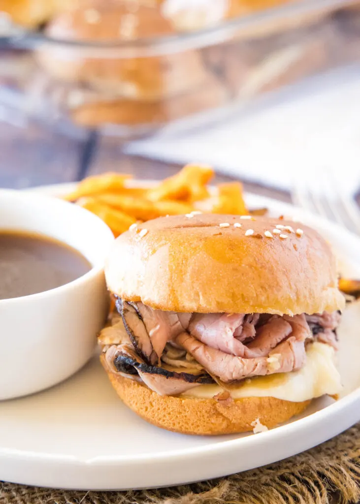 white plate with french dip slider with au jus
