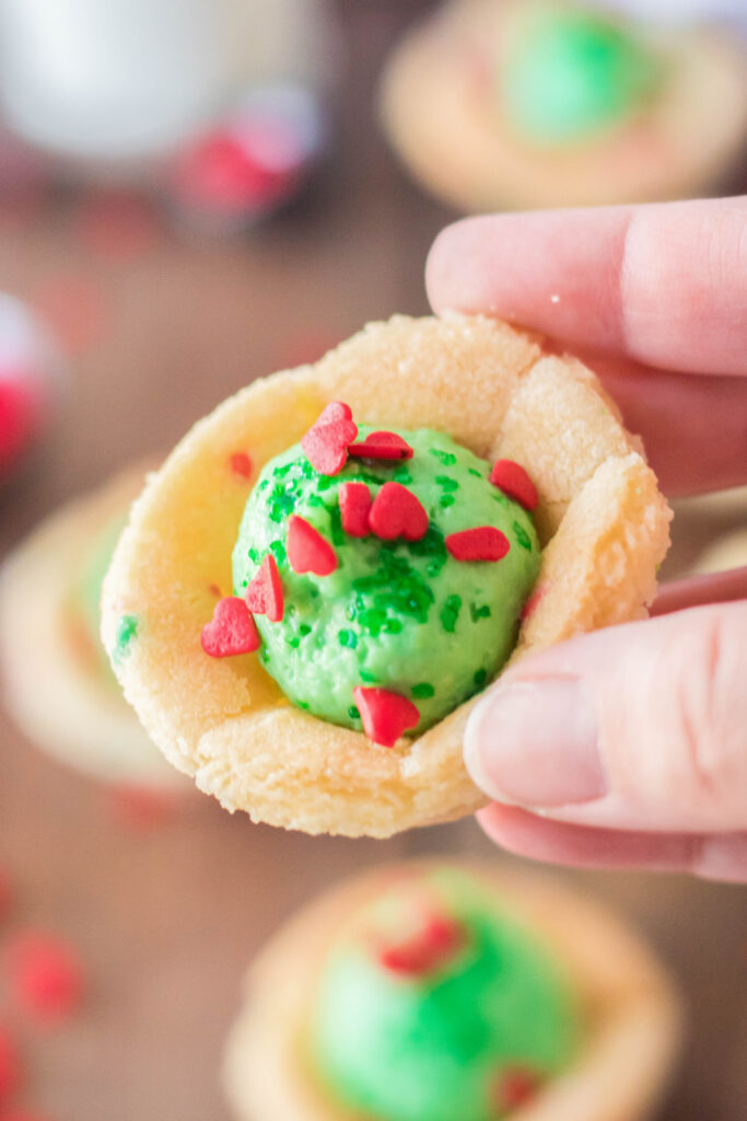 hand holding grinch sugar cookie cups