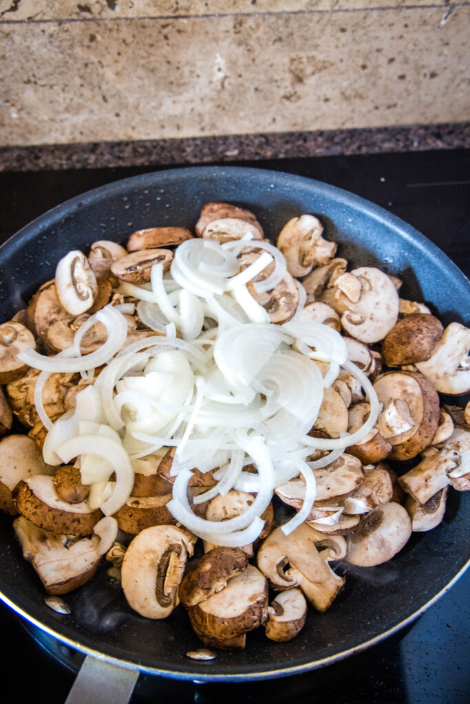 mushrooms and onions in a large skillet