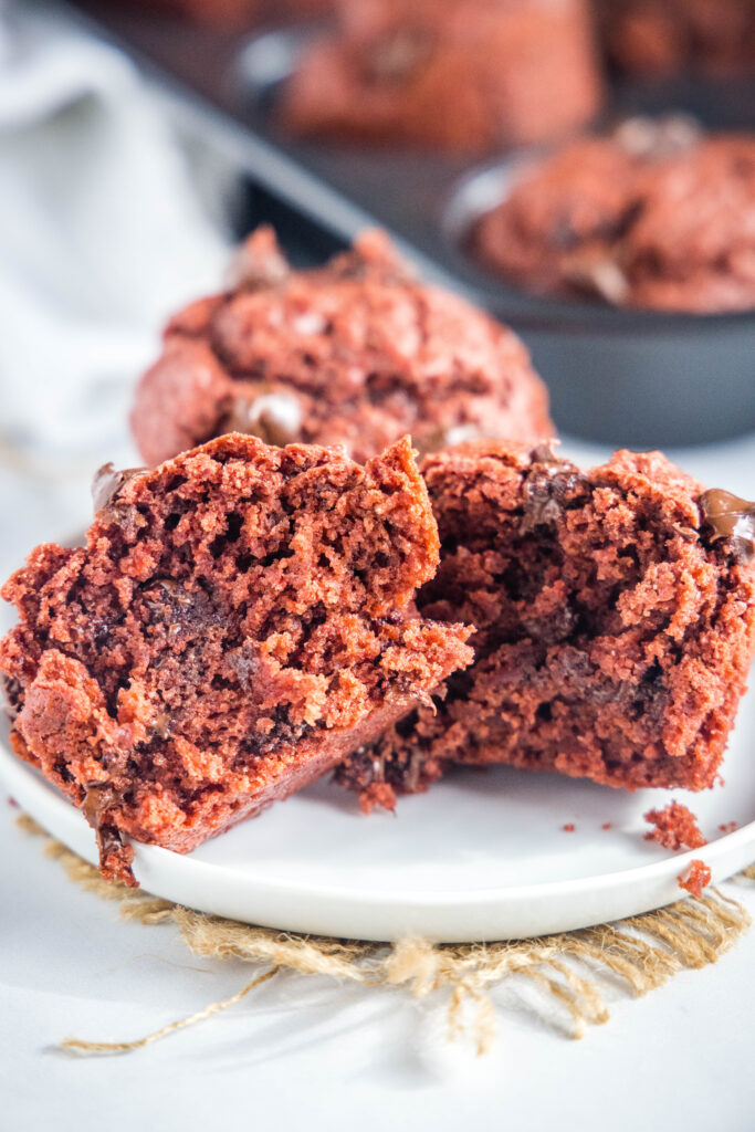 red velvet muffins cut in half on a white plate