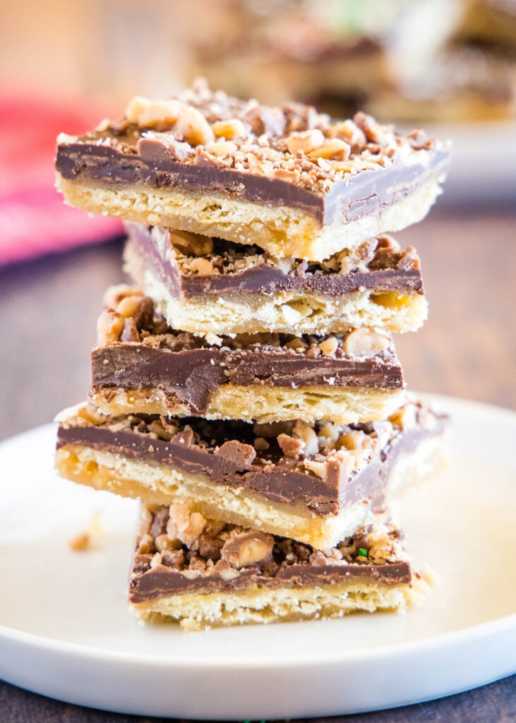 saltine toffee stacked on a white plate