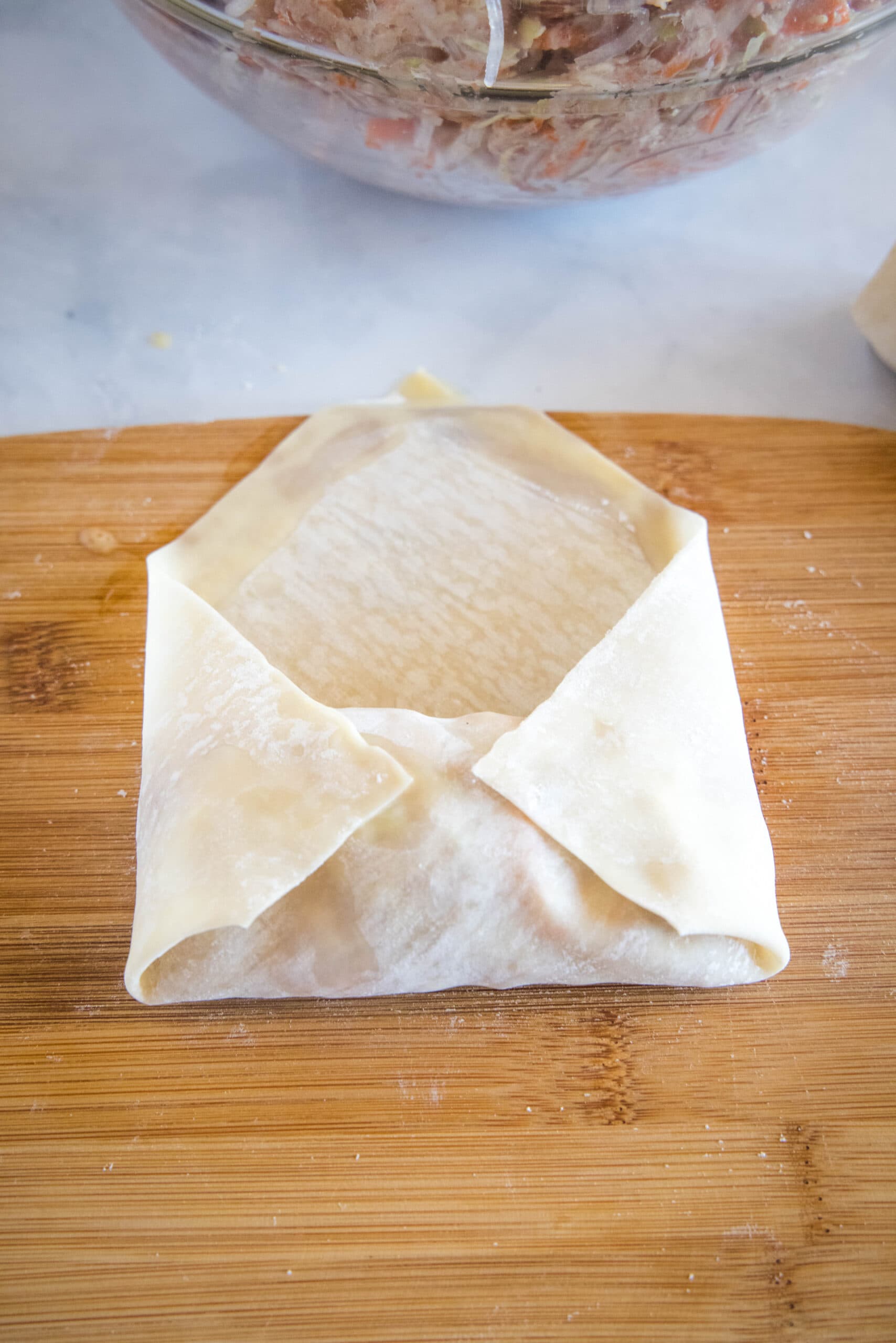 folding the sides over the egg roll filling