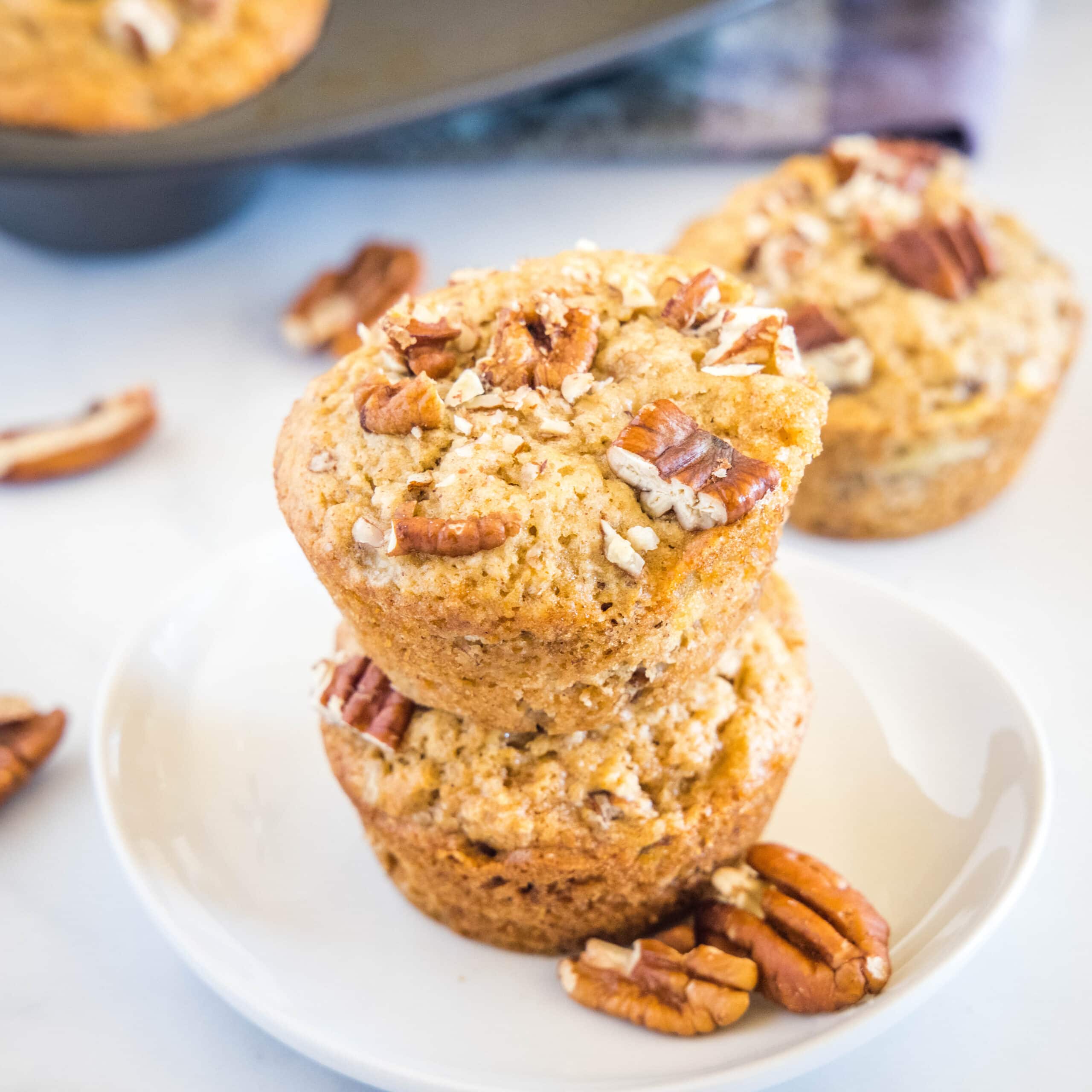 cropped in image of banana nut muffins on a white plate