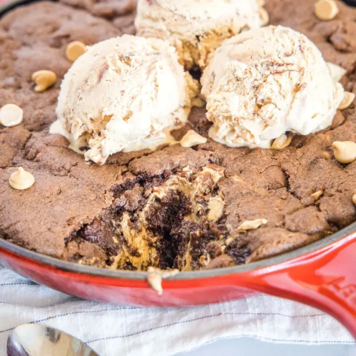 close up chocolate and peanut butter skillet cookie with ice cream on top