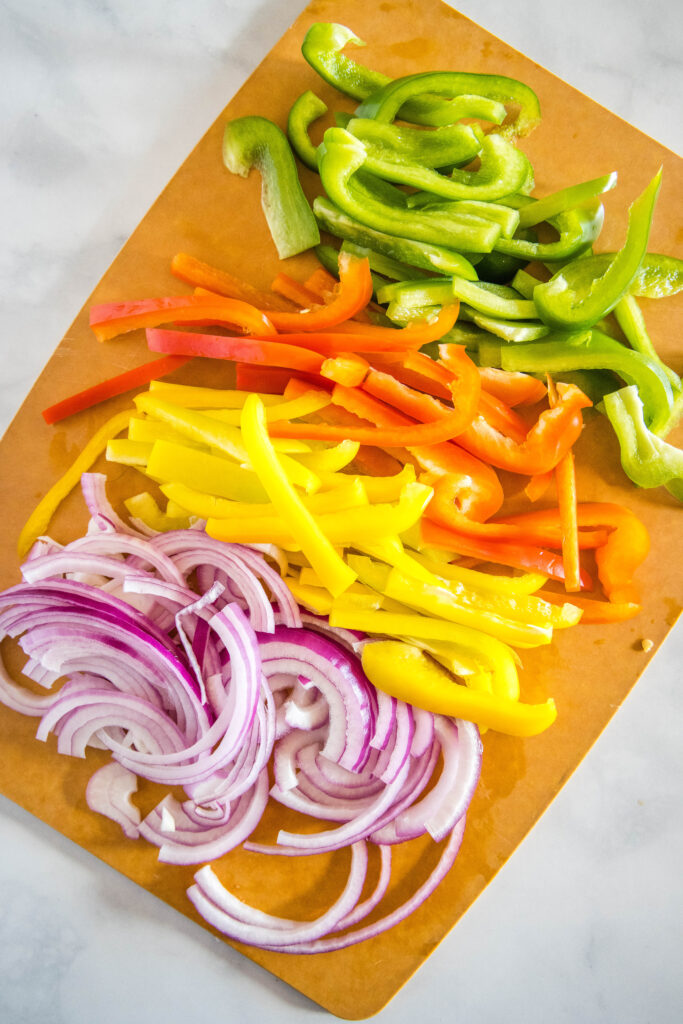 bell peppers and onions on a cutting board