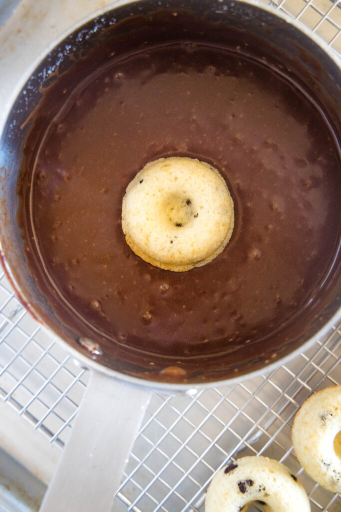 mini donut getting dipped in chocolate glaze