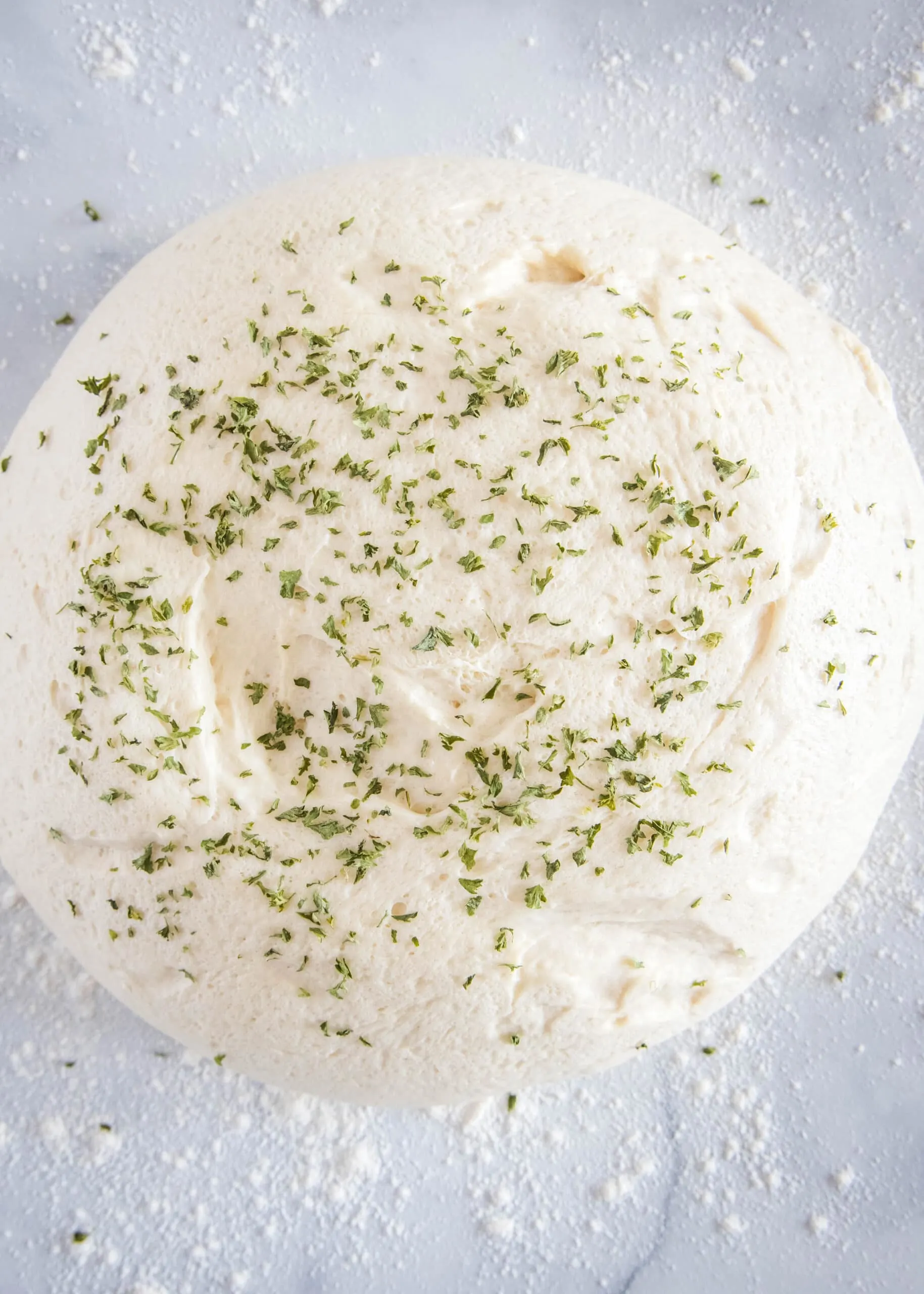 sprinkling chives over bread dough