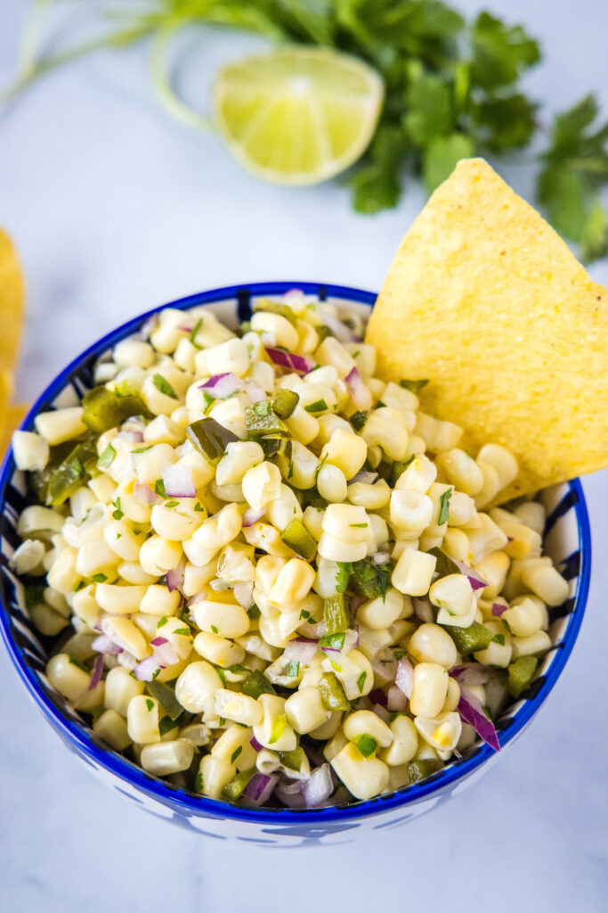 looking down on a blue bowl with chipotle corn salsa
