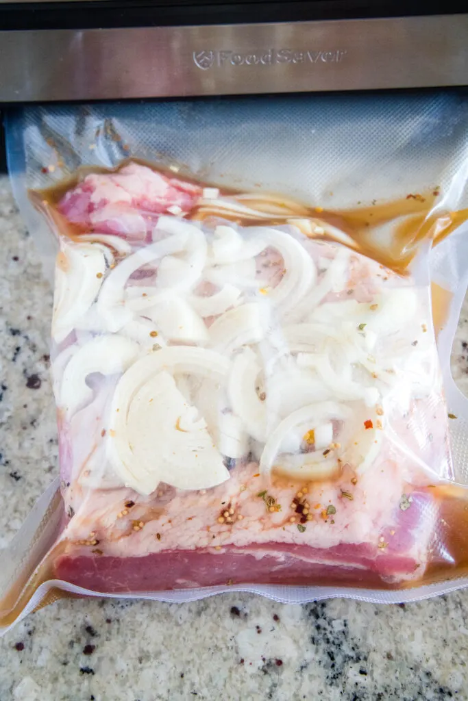 corned beef brisket in bag with onions and beef broth