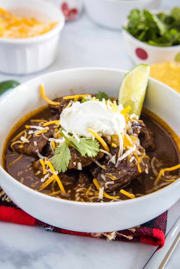 bowl of texas chili with cheese and sour cream