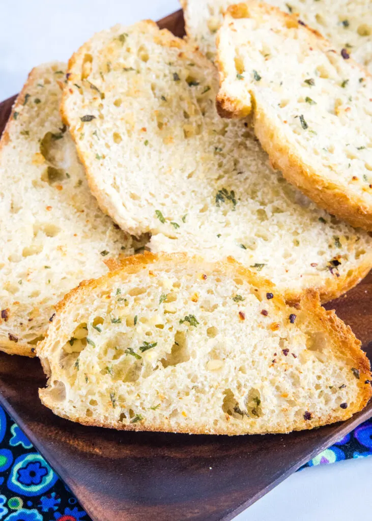 crispy garlic bread on a wood plate