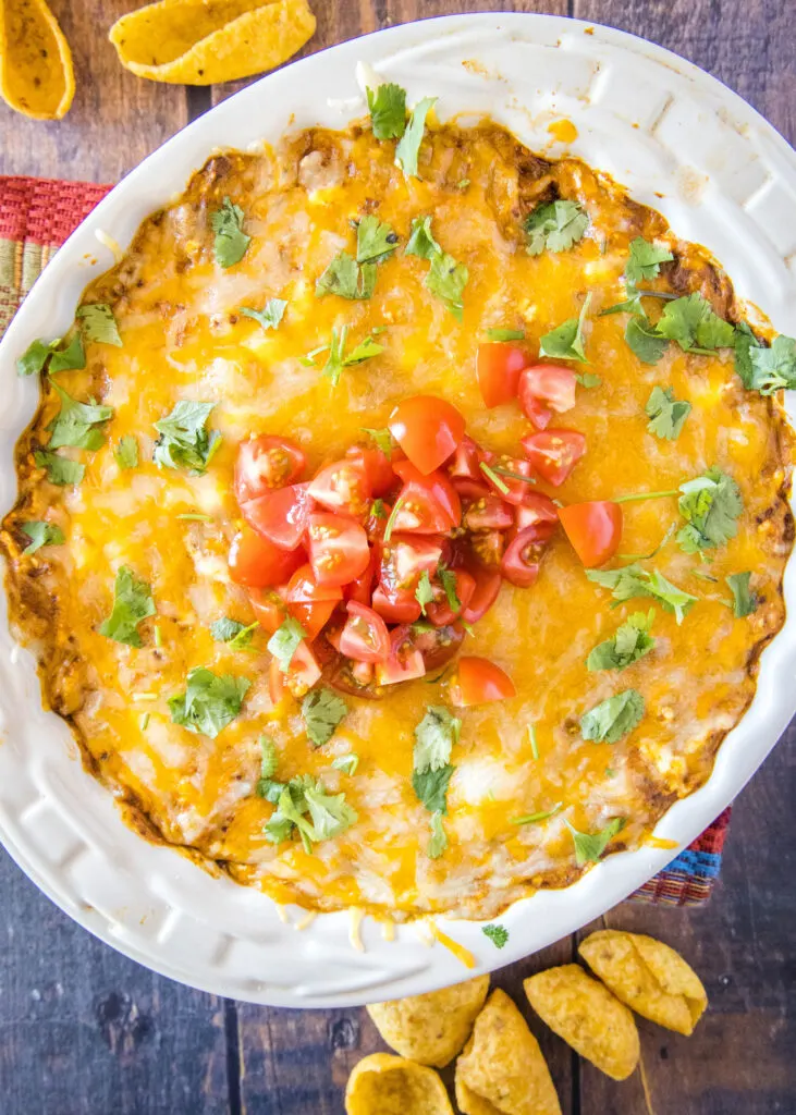looking down on baked chili cheese dip topped with tomatoes