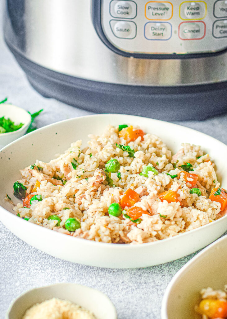 chicken and rice in a bowl in front of the instant pot