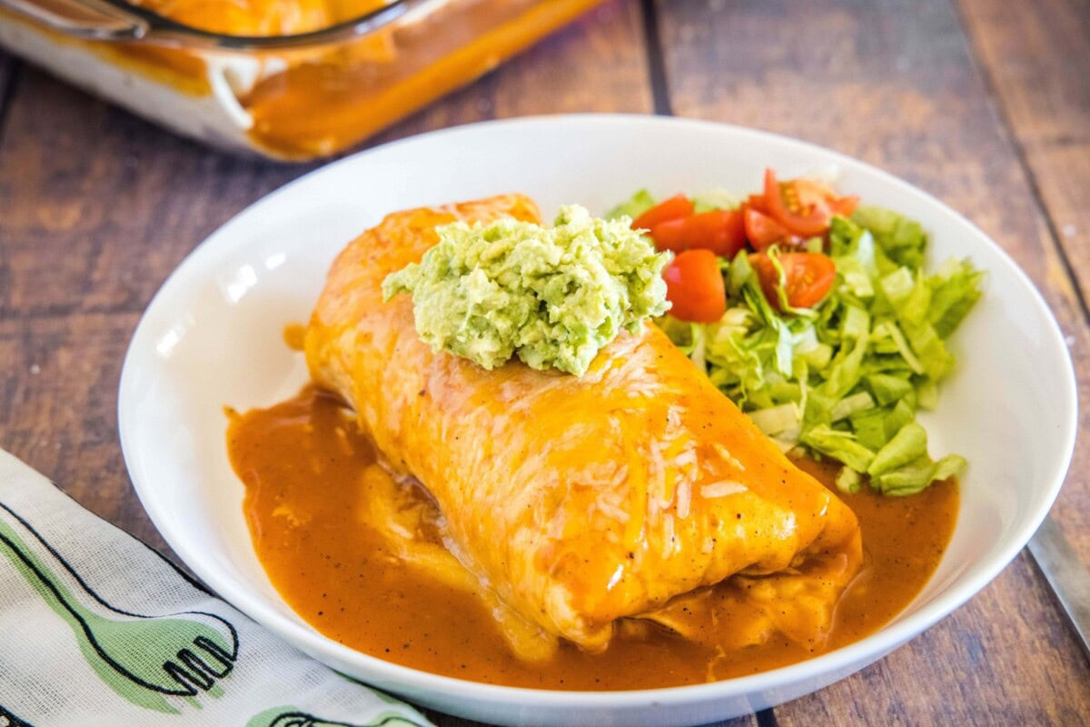 Wet Burrito - a burrito that is loaded with your favorite fillings and then smothered in sauce. It is baked to perfection with melty cheese and then topped with whatever toppings you like!