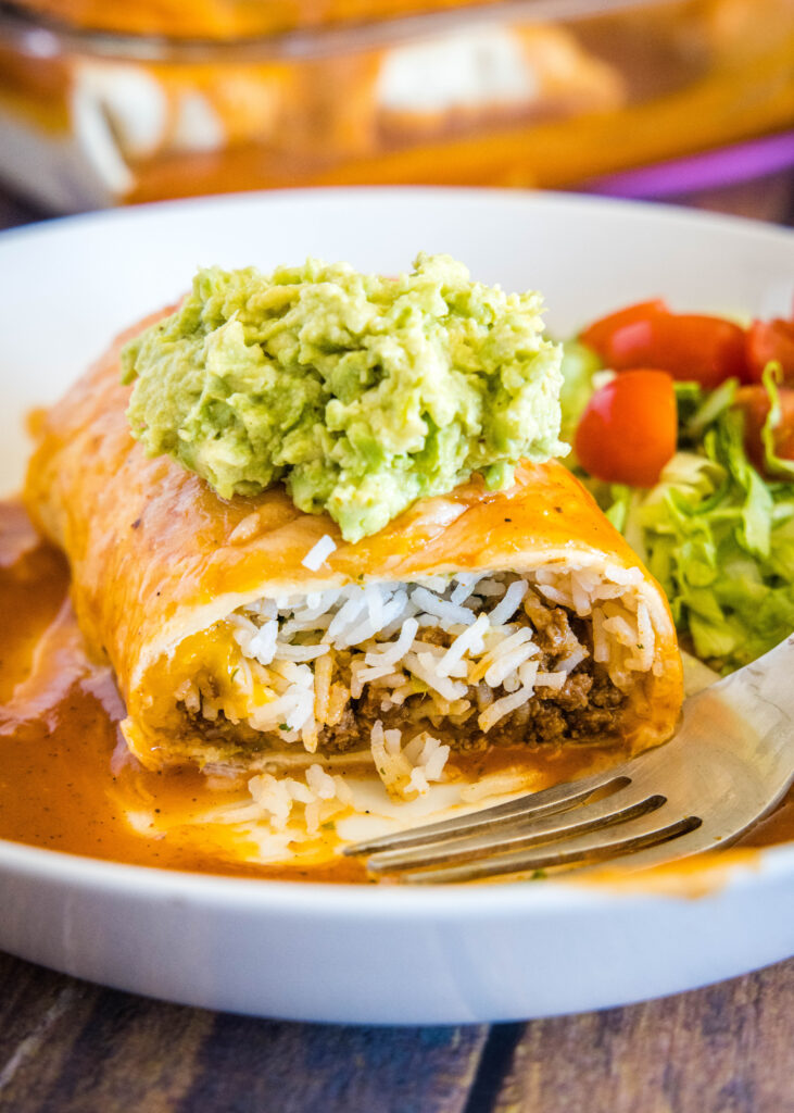 wet burrito cut in half to see the taco meat and rice inside
