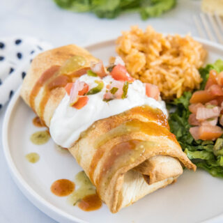 air fryer chimichanga topped with sour cream and tomatoes