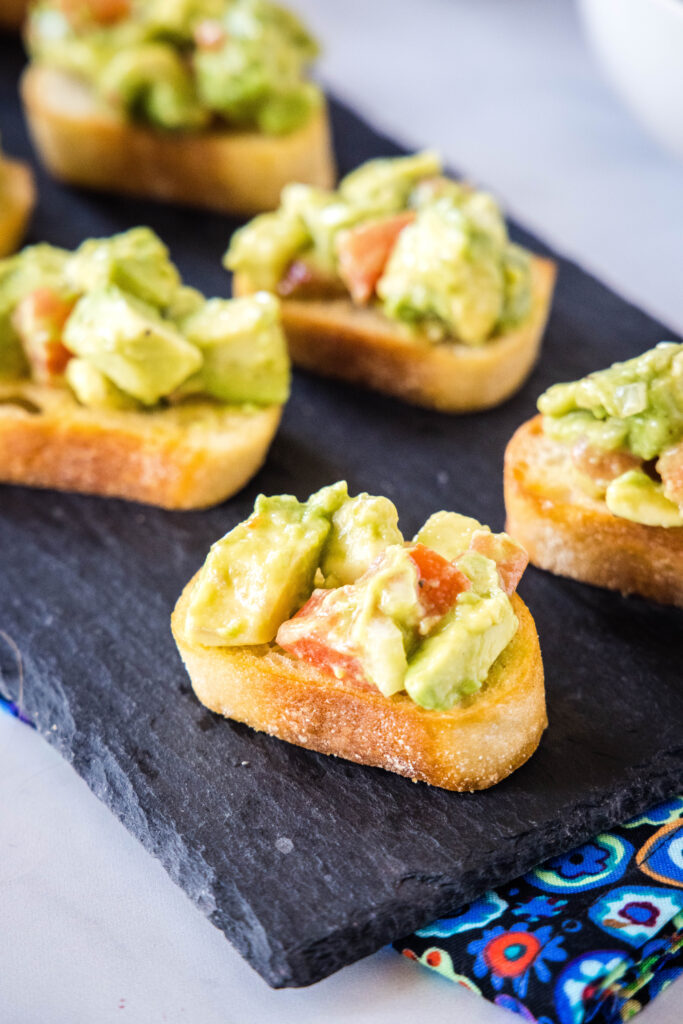 serving tray with baguette slices topped with diced avocado avocado bruschetta | dinners, dishes, and desserts - Avocado Bruschetta 4 683x1024 - Avocado Bruschetta | Dinners, Dishes, and Desserts