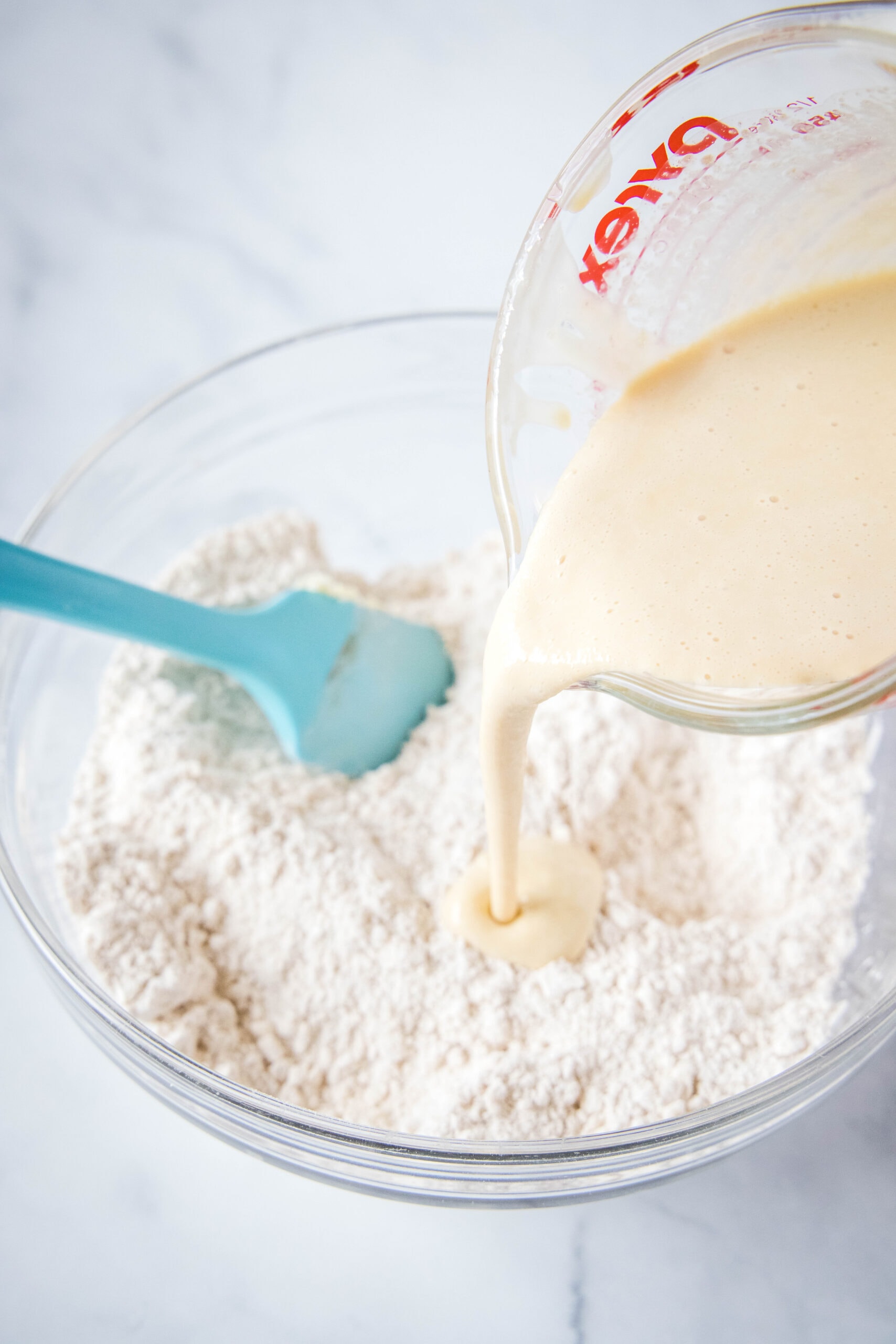 pouring heavy cream into flour mixture
