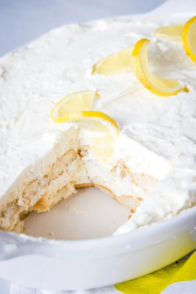 limoncello tiramisu in a baking dish with a piece cut out