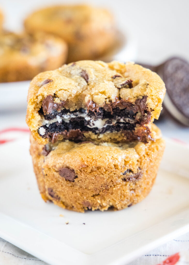 stacked cookies on a plate with a bite taken out of one oreo stuffed chocolate chip cookies - Oreo Stuffed Cookies 6 731x1024 - Oreo Stuffed Chocolate Chip Cookies