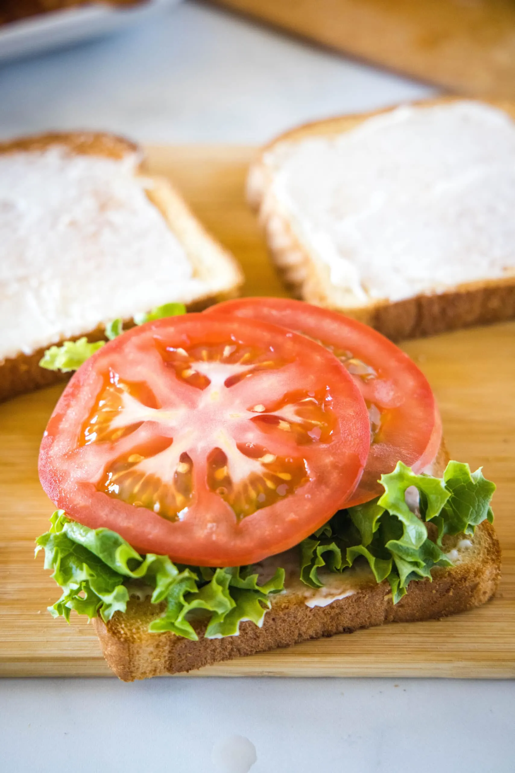 lettuce and tomato on a slice of bread