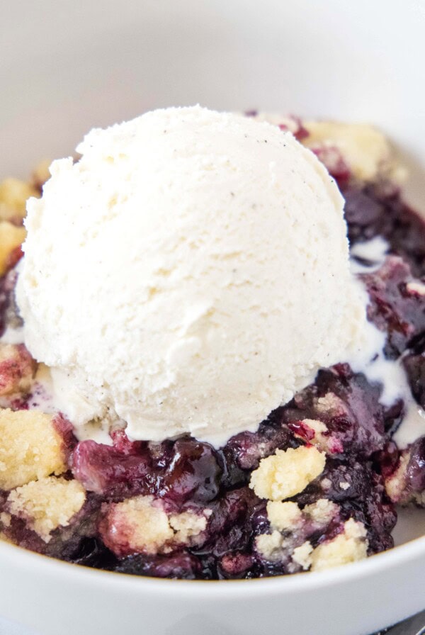 close up cherry cobbler with ice cream in a bowl