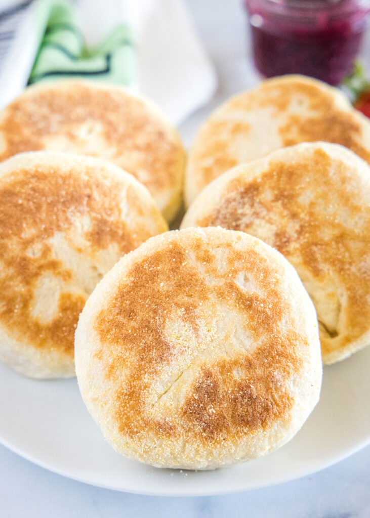 cooked english muffins on a white plate