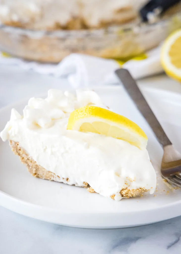 slice of lemonade pie on a white plate with a fork