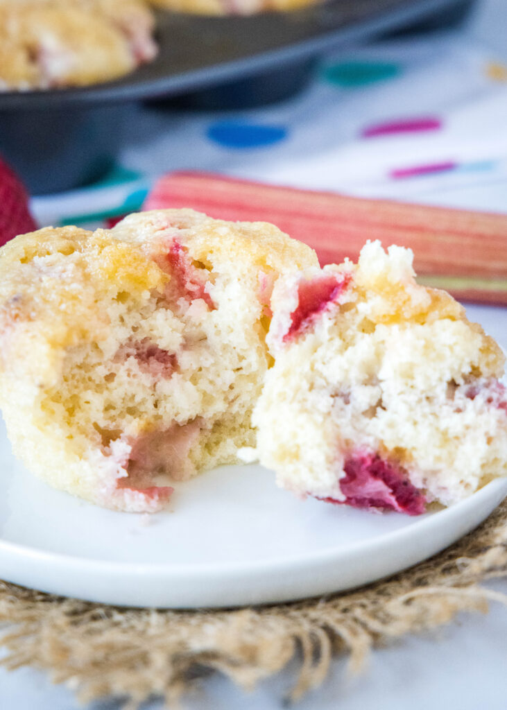 muffin broken in half on white plate strawberry rhubarb muffins - dinners, dishes, and desserts - Strawberry Rhubarb Muffins 7 731x1024 - Strawberry Rhubarb Muffins &#8211; Dinners, Dishes, and Desserts