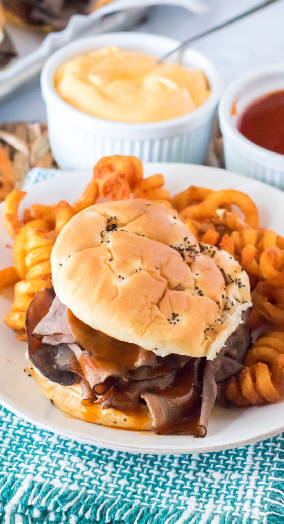 plate with roast beef sandwich and curly fries