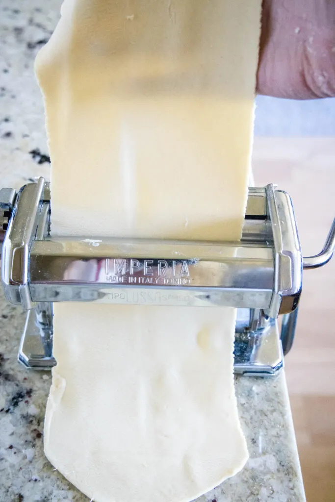putting pasta dough through the roller